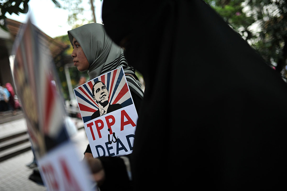 KUALA LUMPUR ,  26/4/2014 .Protesters holding poster of United States America President, Barack Obama during protest of The Trans Pacific Partnership Agreement ( TPPA ) followed by Obama visit into Malaysia.Obama is scheduled to arrive in Malaysia on April 26, after visiting Japan, South Korea and the Philippines. AWANI / SHAHIR OMAR