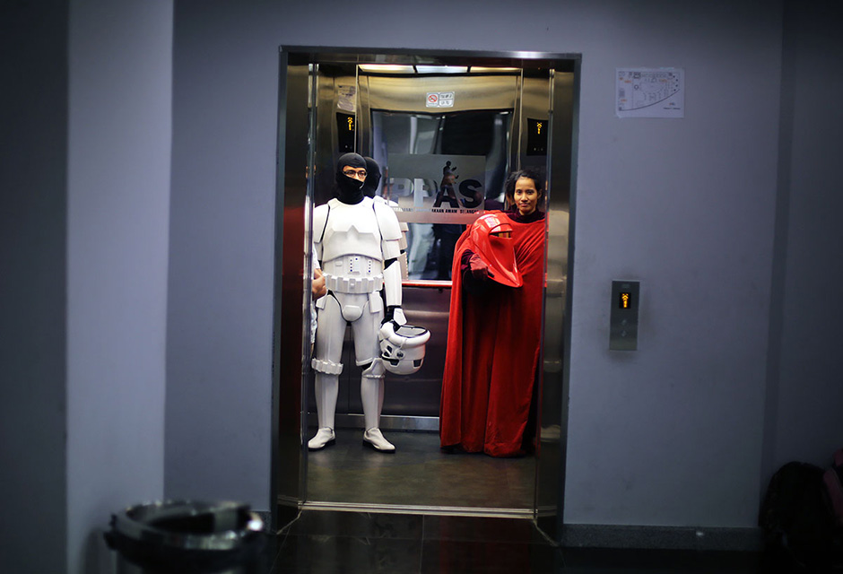 SHAH ALAM , 4/5/2014. Participants dress as ( L ) Storm Troopers and ( R ) Emperor Royal Guards in Star Wars characters goes up an lif during Star Wars Day, May fourth with members of the 501 st Legion at Raja Tun Uda libary Shah Alam. AWANI / SHAHIR OMAR
