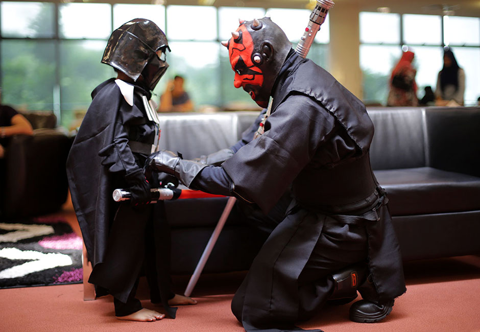 SHAH ALAM , 4/5/2014. A father heleped his son while them dress as Star Wars characters during Star Wars Day, May fourth with members of the 501 st Legion at Raja Tun Uda libary Shah Alam. AWANI / SHAHIR OMAR