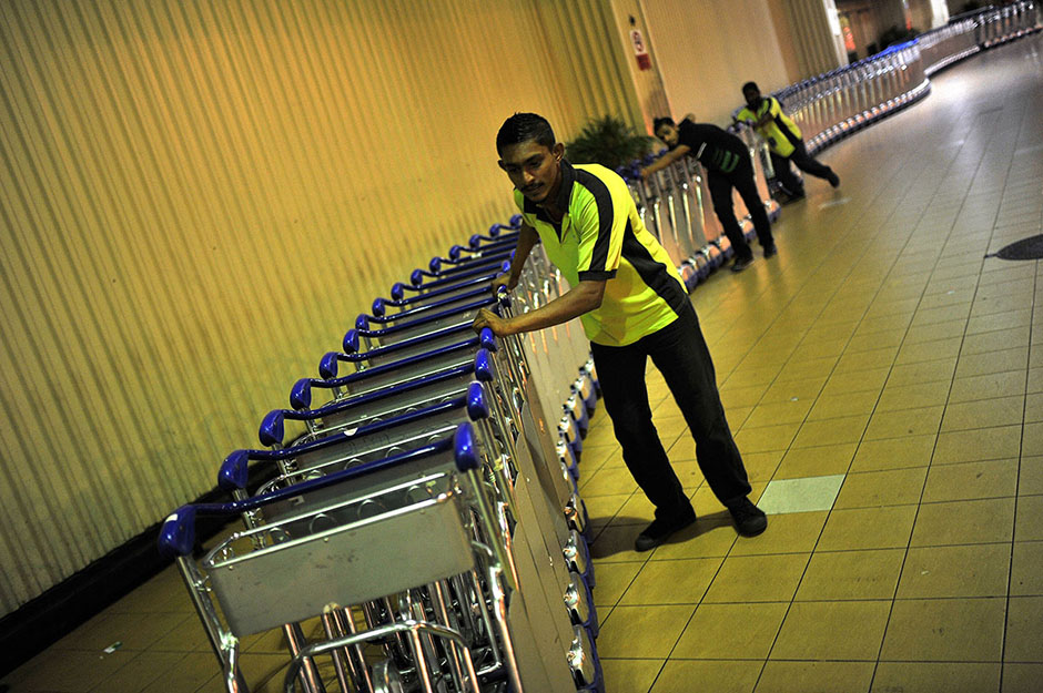 KUALA LUMPUR , 8/5/2014.The Air Asia staff pulling luggage trolleys at Low Cost Carrier Terminal (LCCT) Sepang. On this night LCCT will be last operation and Air Asia will beginning their operation in KLIA2 start on Friday. AWANI / SHAHIR OMAR