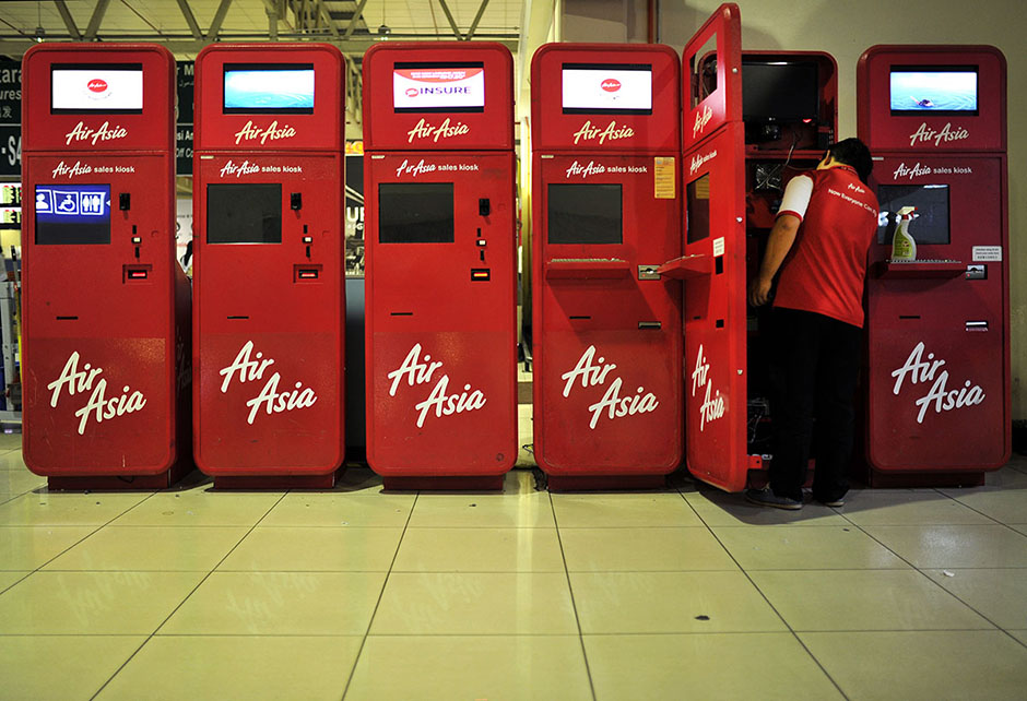 KUALA LUMPUR , 8/5/2014. The Air Asia staff checking sales kiosk machines in Low Cost Carrier Terminal (LCCT) Sepang. On this night LCCT will be last operation and Air Asia will beginning their operation in KLIA2 start on Friday. AWANI / SHAHIR OMAR