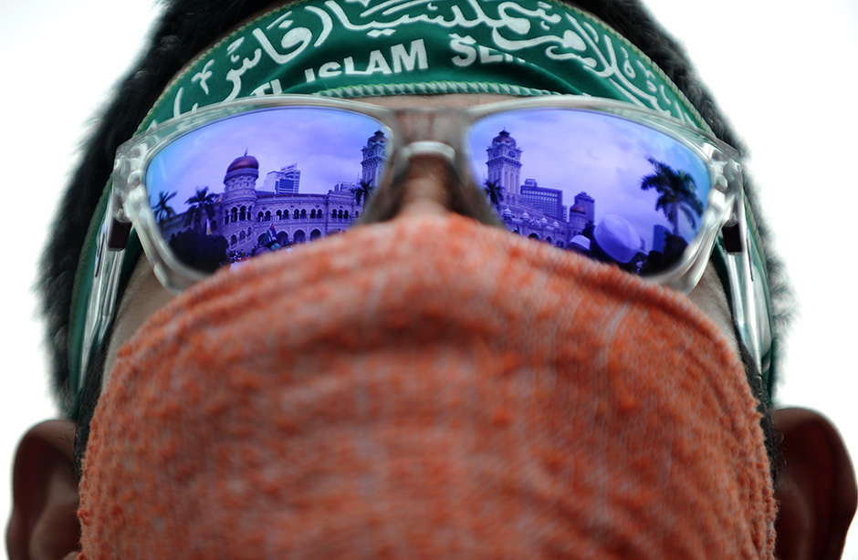 KUALA LUMPUR , 1/5/2014.Reflection of Sultan Abdul Samad building from protestor sunglases during Mayday protest.Malaysia's opposition and activists demonstrate on May Day, also known as Labour Day, against the rising cost of living due to reduced subsidies and increased taxes. AWANI / SHAHIR OMAR